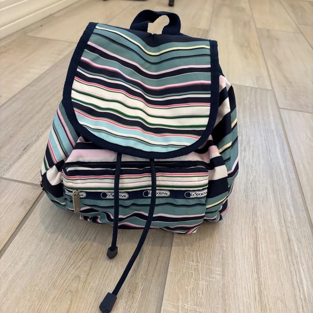 LeSportsac Voyager drawstring backpack in a navy pastel stripe pattern.